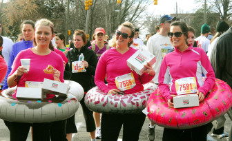 File: 2012. Runners partake in the Krispy Kreme Challenge. 