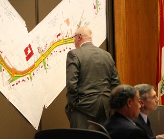 Councilor John Odom takes a closer look at the Leesville Road widening project map during Tuesday night’s public hearing. 