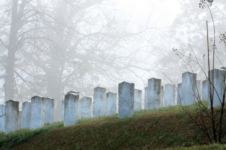 File: March, 2012. Confederate graves emerge from the mist in the Oakwood Cemetery. 
