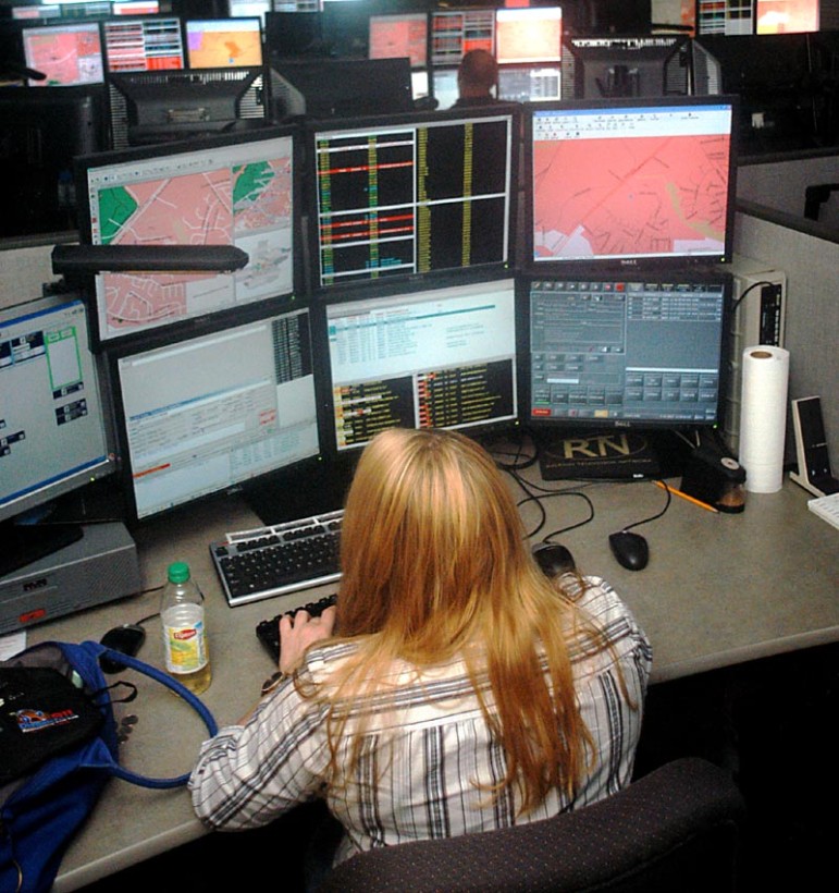 Kelly Junker, of Raleigh, handles incoming 911 calls Thursday afternoon. Junker has been working at the center for the past two years. 