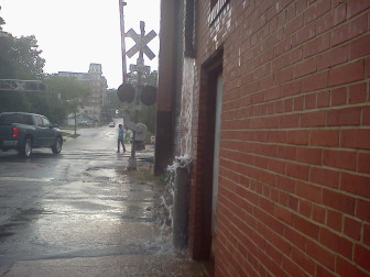 Stormwater flows from a gutter system along Hargett Street in downtown Raleigh.