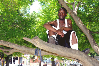 Tony Smith from Georgia, stays cool up in a tree in Moore Square.