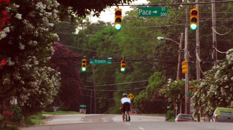 A bicyclist has all of Person Street to himself for an evening ride.