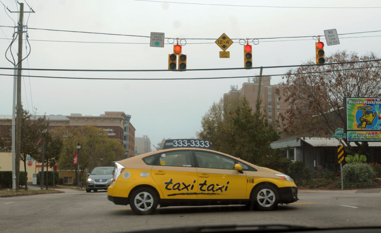 A TaxiTaxi crosses Glenwood at Peace Street.