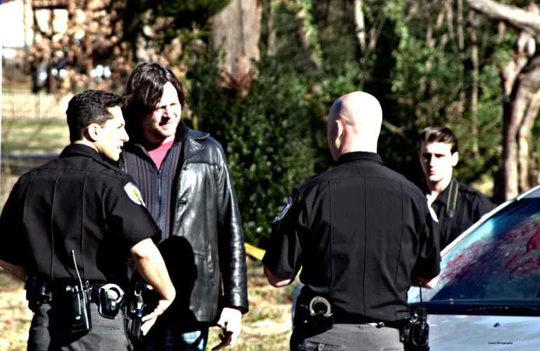 Director Rob Underhill, center, works with actor Michael Rosander, left, and Officer Robert Wagner, right, on how a crime scene takes place in the movie "Bragg 'N East." Members of Wake County EMS volunteered to help with the scene.