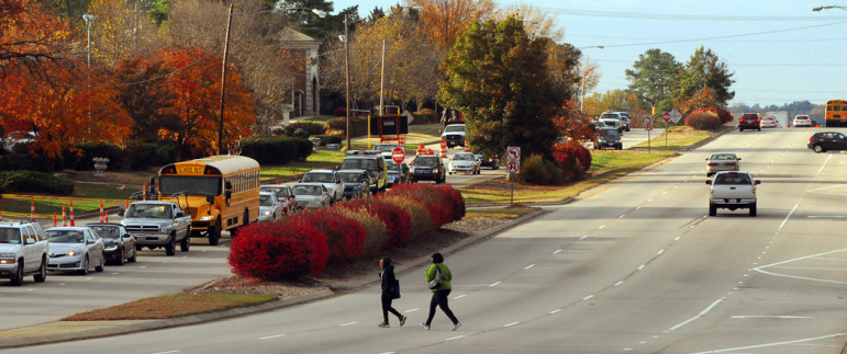 Pedestrians rush to cross six lanes on Glenwood Avenue just north of Pleasant Valley Road. 