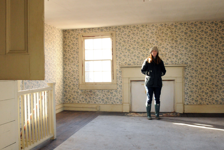 Lauren Werner stands in a back bedroom, which is in the "newer" part of house.