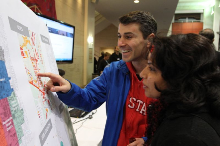 Shamsa and Francesco Visone, who live in Glenwood South, study a map of the downtown boundaries at Tuesday's downtown plan kick off.