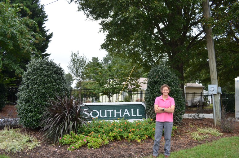 Kay Metzner stands proudly outside her Southall neighborhood