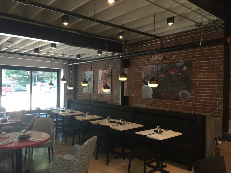 Luke Buchanan's paintings hang in one of the front wings of the restaurant