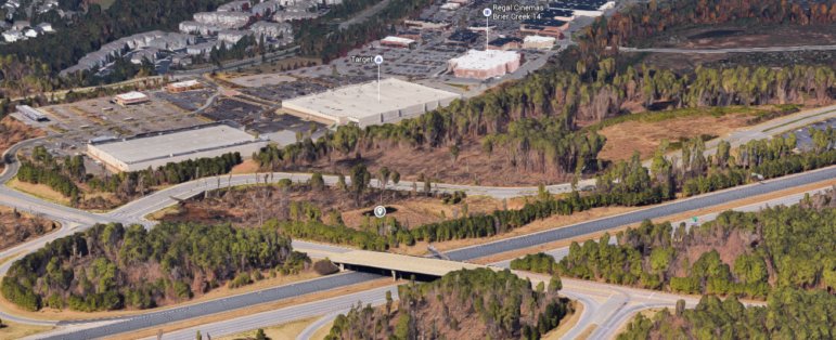 The hotel will be built on this prime piece of land between the highway and the highway off-ramp