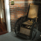 A wheelchair remains on the front porch of Pope House.