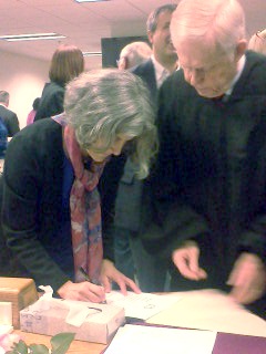 Christine Kushner signs the oath of office.