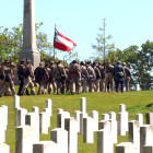 Confederate soldiers march through the Confederate section of Oakwood Cemetery at the close of the ceremony.