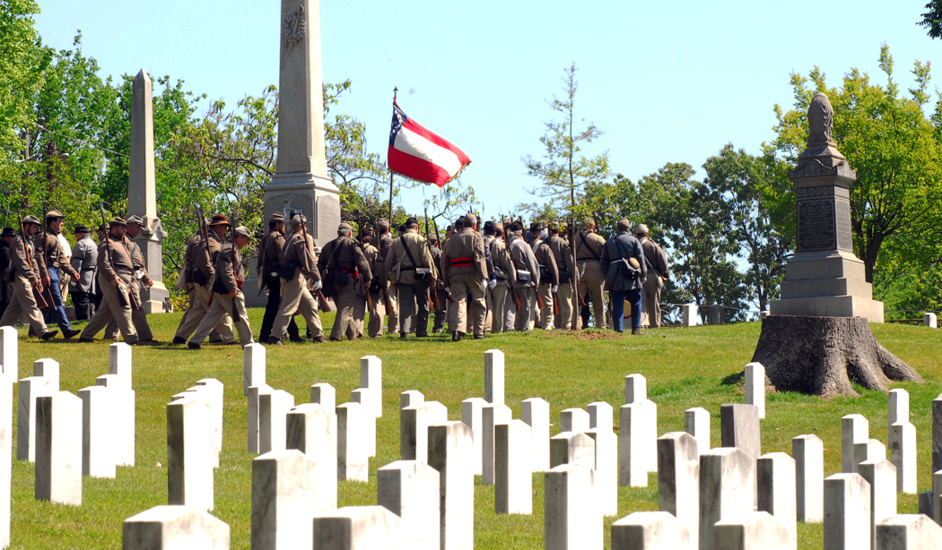 Confederate soldiers march through the Confederate section of Oakwood Cemetery at the close of the ceremony.